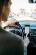 © Westend61 - Woman driving in a car through the city using a telephone navigation app