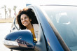 © Westend61 - Happy woman looking out of car window