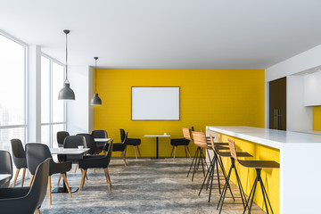 Bright yellow restaurant interior with poster