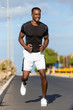 © Samuel B. - Black african american young man stretching after outdoor jogging
