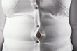 © New Africa - Overweight woman in tight shirt, closeup. Obesity and weight loss