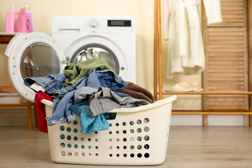 Poster - Basket with dirty laundry near washing machine indoors