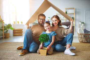 concept housing   young family. Mother father and child in new house with  roof at home.