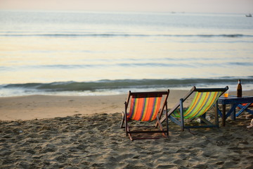 The view of the beach, the beach and the sun loungers are rising. Beautiful golden yellow sky and sun