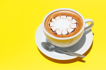 Coffee cup of hot latte art on Yellow background.