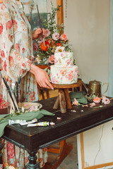 Wall Mural - Tea time, Woman hands holding tea pot, flowers and cake