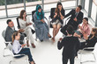© InfiniteFlow - Businesswomen and businessmen attending group meeting conference in office room. Corporate business team concept.