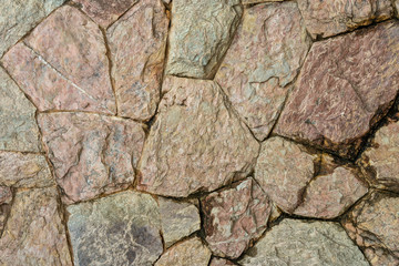 Close up grunge stone wall of the large colored cement