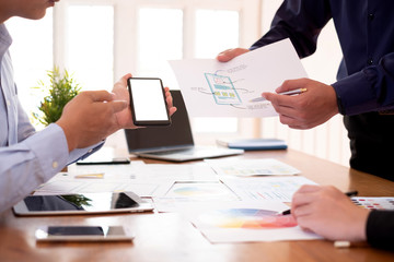 Creative designers planning work together on applications on mobile phone and websites.