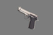 © OlekStock - New glossy metal pistol on gray table. Top view