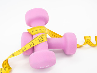 Fitness equipment with dumbbells and measuring tape isolated on a white background. Healthy with exercise concept.