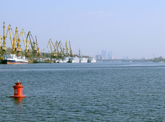 View of the river, the port with ships and red buoy