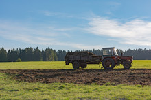 Tractor With Trailer On A Field