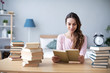 © BestForYou - Woman smiling student read books at home.