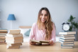 © BestForYou - Woman smiling student read books at home.