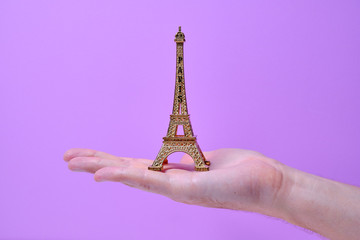 Eiffel tower handed by hand close up