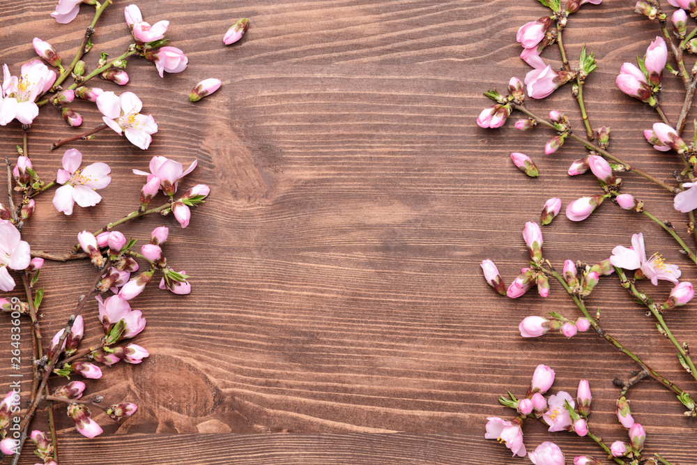 Beautiful blossoming branches on wooden background
