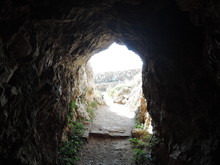 View From Inside A Rocky Cave In Fortezza Fortress, The Greek City Of Rethymno. The Hill Of Paleokastro. Cave.