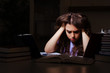 © Elnur - Young female student preparing for exams late at home