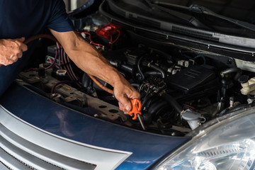 Checking a car engine for repair at car garage