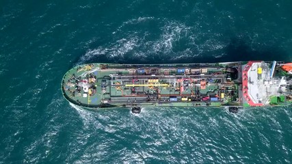 Wall Mural - Large crude oil tanker roaring across The Mediterranean sea - Aerial footage following the ship