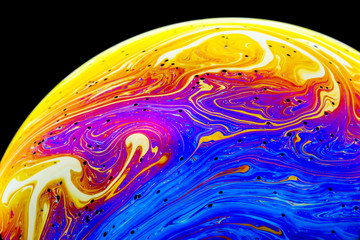 Wall Mural - multicolored rainbow colors of a single soap bubble that looks like a fantasy planet isolated agains