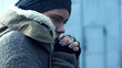 Female beggar feeling cold outdoors, homelessness problem, poverty despair