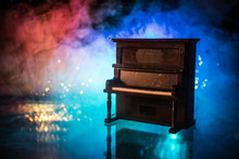 Creative Concept. Artwork Decoration With Piano On Dark Toned Foggy Background With Light.