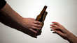 Hand giving beer bottle to alcohol addict with self-inflicted arm, harmful habit