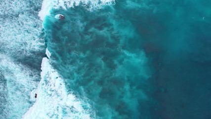 Wall Mural - waves and azure water as a background. view from high rock at the ocean surface. natural summer seas