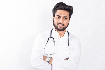 Poster - Handsome young doctor in a white coat with a stethoscope. Health care concept.