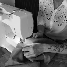 Sewing With A Sewing Machine In Black And White