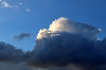 Dark forming clouds with blue sky elements right before a thunderstorm