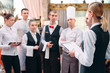 © davit85 - restaurant manager and his staff in kitchen. interacting to head chef in commercial kitchen.