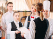 © davit85 - restaurant manager and his staff in kitchen. interacting to head chef in commercial kitchen.