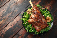 Roast Lamb Leg With Rosemary And Garlic. On Black Plate, Wooden Table