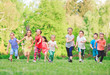 © davit85 - Many different kids, boys and girls running in the park on sunny summer day in casual clothes