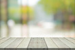 © sorrapongs - Empty wood table top on green blur background at shopping mall