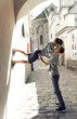 © Vadym - young couple kissing in the street of the old city near the wall. Young boy holding his girlfirend and kissing