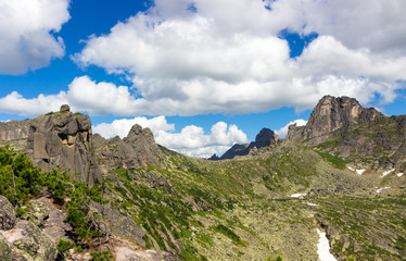 Wall Mural - Majestic landscape of a mountain pass in sunny weather. Tops of the mountains with stunning clouds on a summer day. Western Sayan mountains, Ergaki range, Siberia, Russia. Adventure concept background