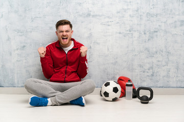 Wall Mural - Redhead sport man celebrating a victory in winner position