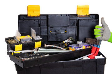 Wall Mural - Tool box isolated. Black plastic tool kit box with assorted tools and a glove showing the thumb up sign for good work isolated on a white background.