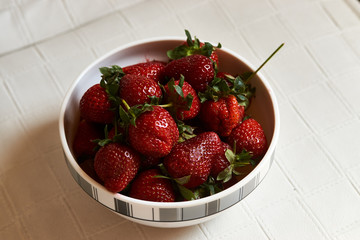 Wall Mural - Red fresh strawberry in a bowl on white background with copy space