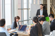 © feeling lucky - caucasian lecturer giving public presentation with company business graph result on white board in meeting room and multiethnic business people are paying attention (training or seminar concept)