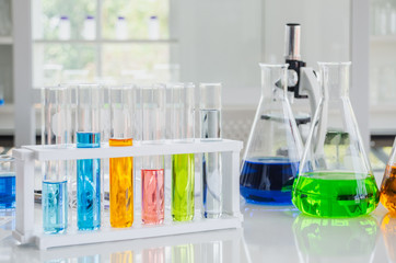 Wall Mural - test tubes and beakers in white laboratory with microscope no people.
