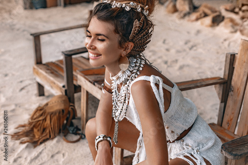 Fotomural close up portrait of beautiful young stylish boho woman walking on the beach at