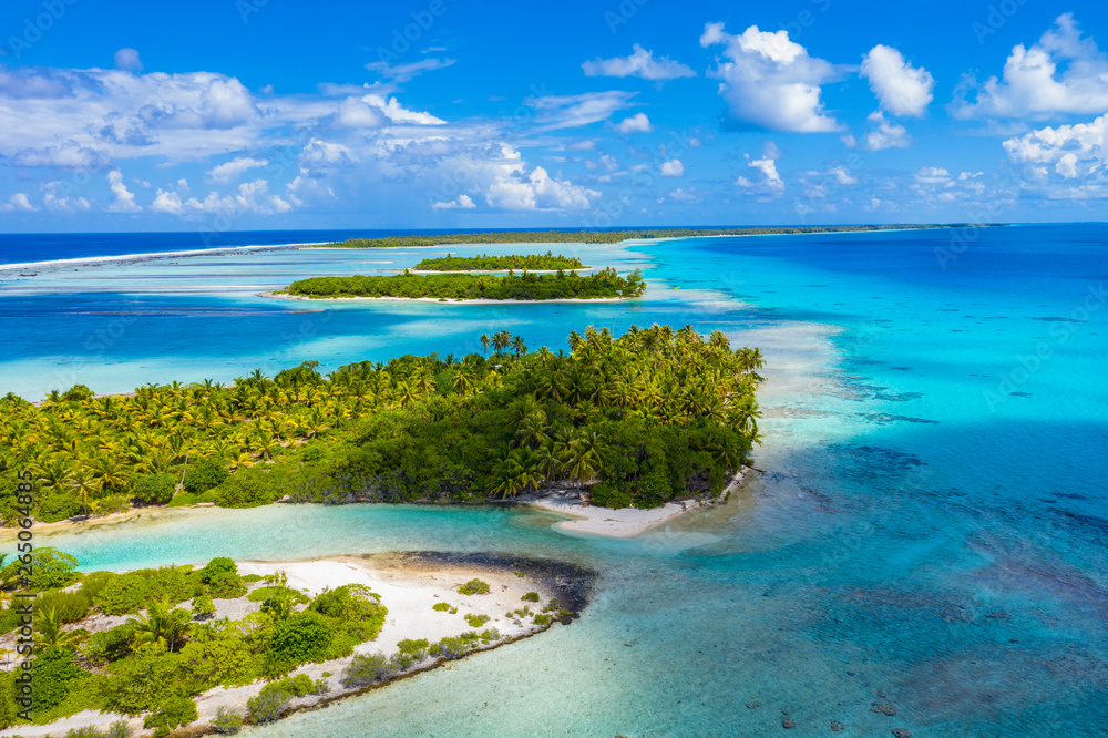 Drone aerial video of Rangiroa atoll island motu and coral reef in French Polynesia, Tahiti. Amazing nature landscape with blue lagoon and Pacific Ocean. Tropical travel paradise in Tuamotus Islands. - obrazy, fototapety, plakaty 