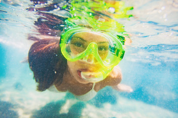 Snorkel water sport activity young Asian woman swimming underwater with snorkeling mask on Caribbean travel vacation having fun. Beach watersport active lifestyle.