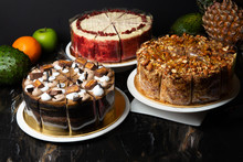 Various Cakes On Display With Dark Background