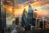 City of London, UK. Skyline view of the famous financial bank district of London at golden sunset hour. View includes skyscrapers, office buildings and beautiful sky. 